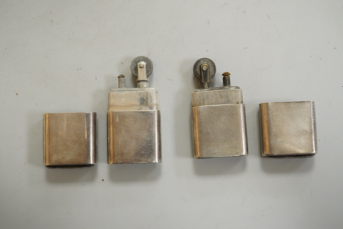 A near pair of George VI silver mounted lighters, each inscribed 'The Howitt Lighter', by Dudley Russell Howitt, Sheffield, 1946, (one engine turned), 58mm.